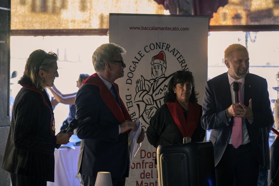 Un intervento al microfono accanto allo stendardo della Confraternita